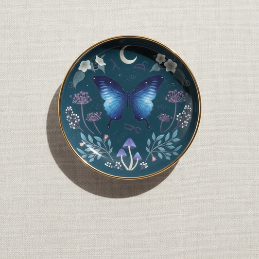 Midnight Moth Celestial Trinket Dish featuring a blue night sky design with a butterfly motif and gold edging, displayed on a soft neutral background – for Carpe Diem Dream.