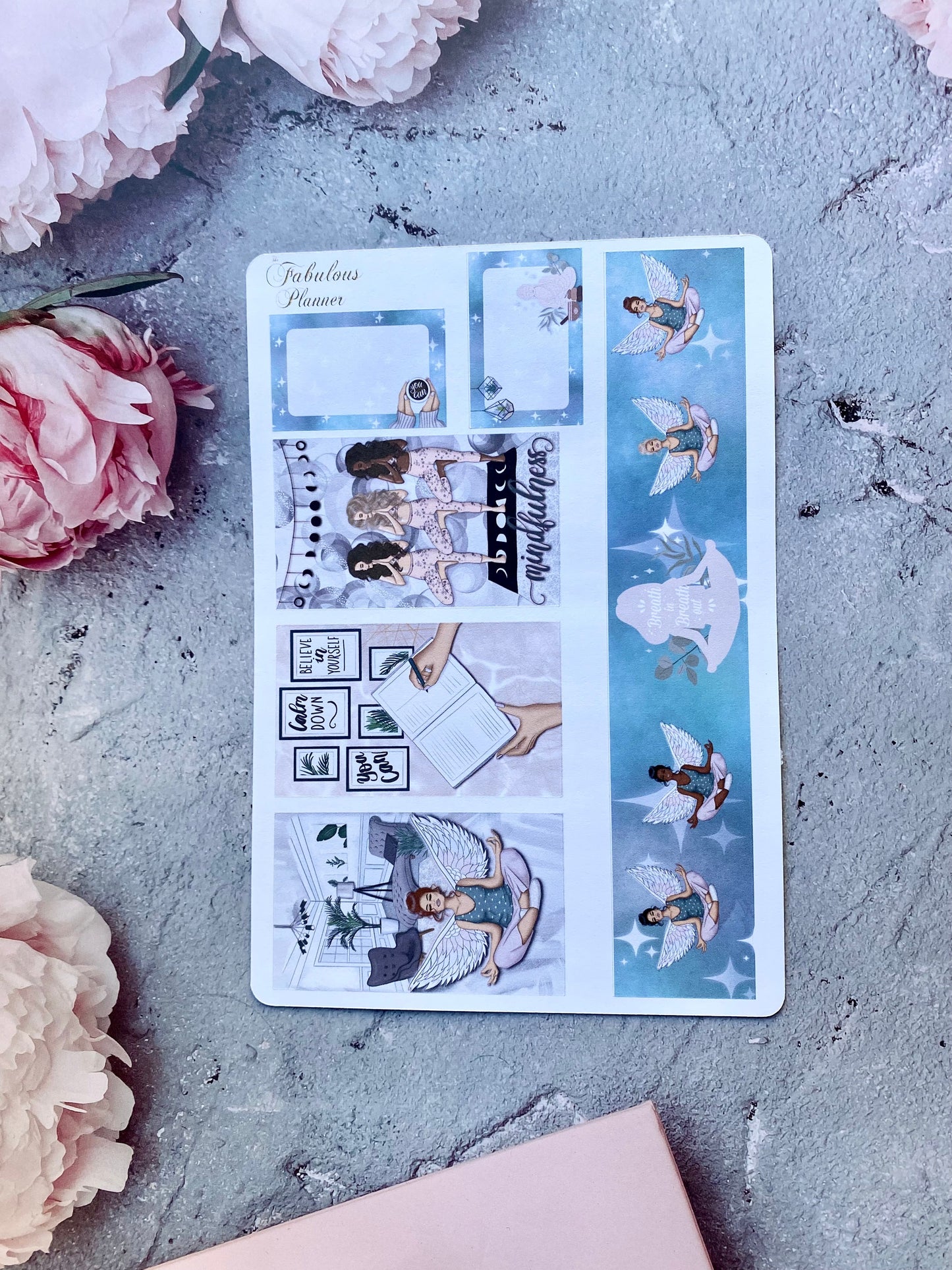 Single 4x6 mindfulness and self care planner sticker sheet featuring blue illustrated panels, journaling scenes, and decorative accents arranged on a textured surface with pink flowers — for Carpe Diem Dream