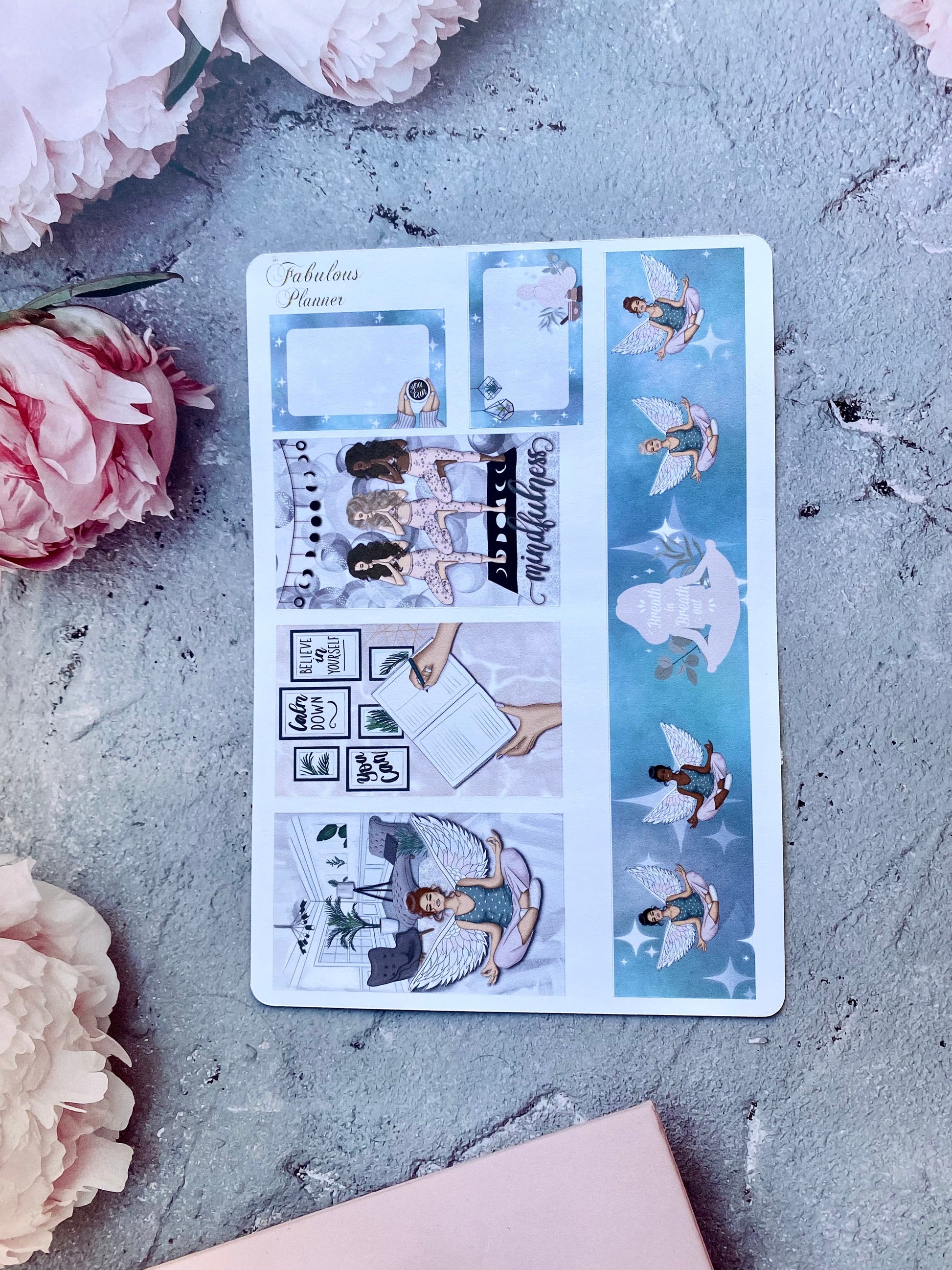 Single 4x6 mindfulness and self care planner sticker sheet featuring blue illustrated panels, journaling scenes, and decorative accents arranged on a textured surface with pink flowers — for Carpe Diem Dream