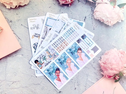 Four 4x6 inch mindfulness and self care planner sticker sheets fanned out on a textured surface with pink flowers — for Carpe Diem Dream
