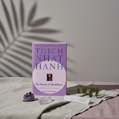 The Miracle of Mindfulness paperback book by Thich Nhat Hanh displayed with amethyst, selenite, and botanical shadows in a calm studio setting. — for Carpe Diem Dream