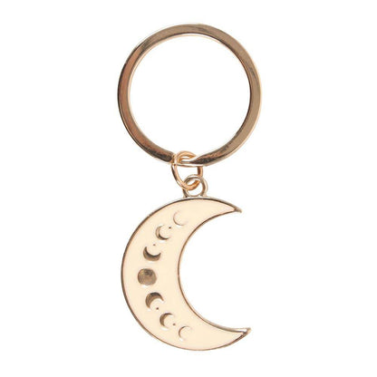 Close-up of the Moon Phase Celestial Keychain featuring a gold-tone crescent moon charm with lunar phase design on a white background, styled for Carpe Diem Dream.