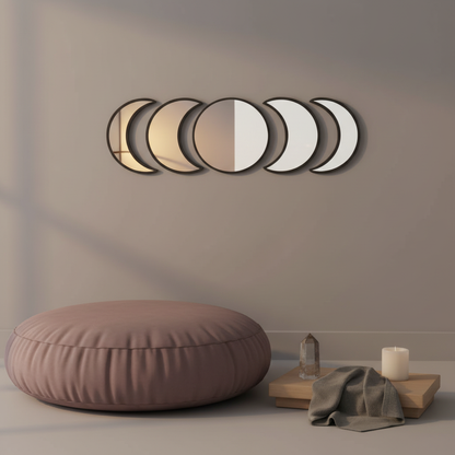 Black five-piece moon phase wall mirror set displayed above a mauve floor cushion with a wooden tray, crystal, candle, and draped cloth in a calm meditation corner. — for Carpe Diem Dream