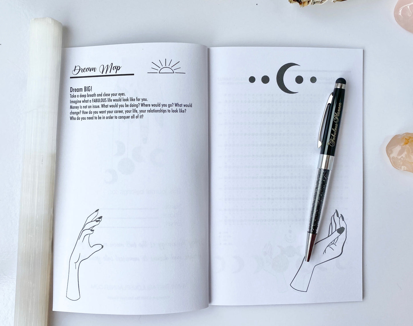 Interior spread of Moon Rituals & Manifestation Journal showing Dream Map page with moon phase graphics and lined journaling page with pen on a white background — for Carpe Diem Dream