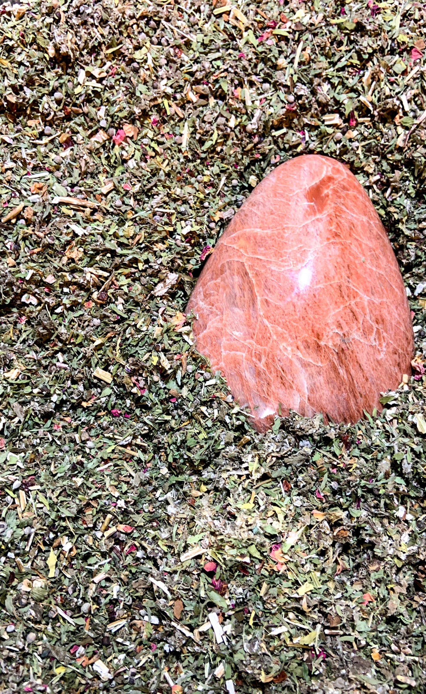 Organic loose-leaf herbal tea ingredients with polished Moonstone crystal for Moon Time Ease Tea – Organic Crystal-Infused Tea. — for Carpe Diem Dream
