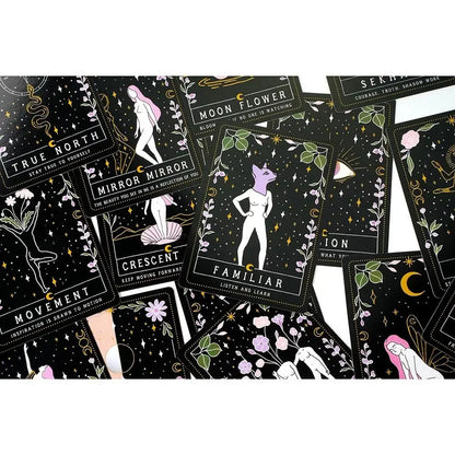 A close-up spread of Moon Witch Oracle cards featuring celestial, floral, and symbolic illustrations arranged across a dark background. — for Carpe Diem Dream