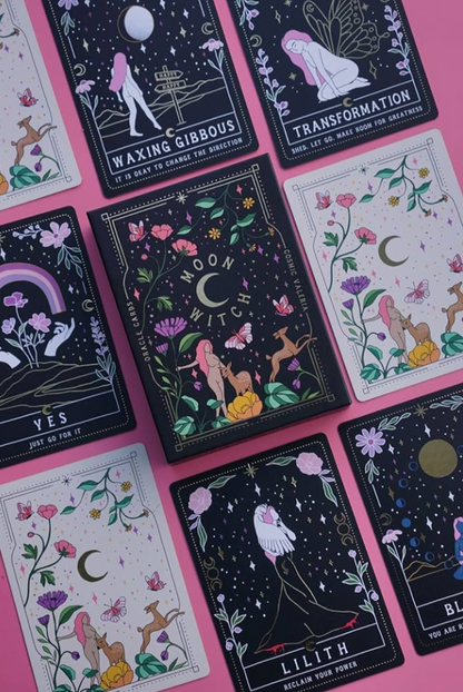 A close-up of Moon Witch Oracle cards with celestial and floral illustrations arranged on a pink background showing detailed card artwork. — for Carpe Diem Dream
