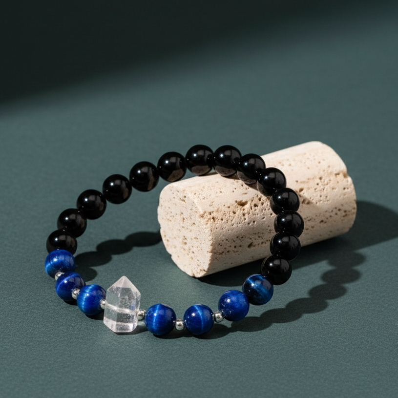 Negativity Filter gemstone bracelet displayed on travertine pedestal against soft green backdrop with natural lighting and gentle shadow. — for Carpe Diem Dream