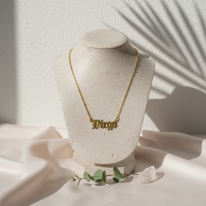 Gold Old English Zodiac Virgo Necklace with astrology lettering on botanical pink silk travertine background for Carpe Diem Dream