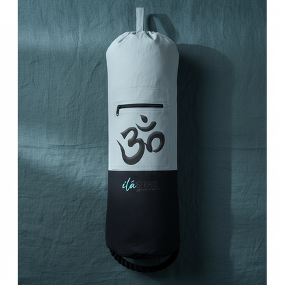 White and black Om yoga mat bag with zip pocket displayed on deep teal textured linen backdrop. — for Carpe Diem Dream
