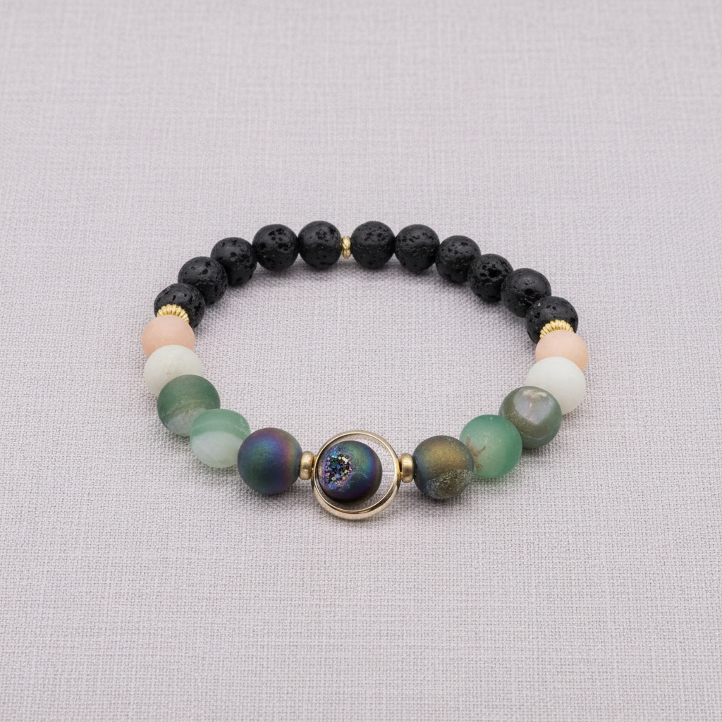 A natural stone and lava bead stretch bracelet with a round orbital focal bead and gold accents displayed on a textured linen background. — for Carpe Diem Dream
