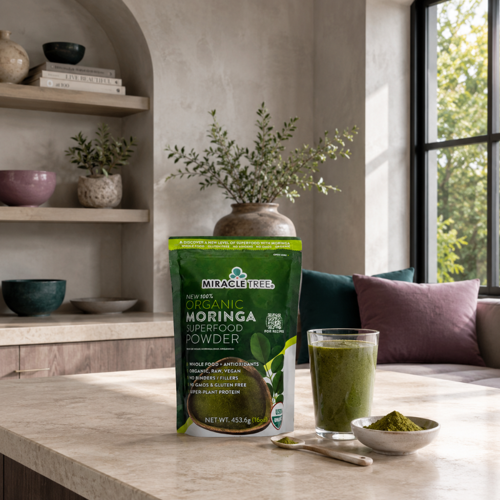 Organic Moringa Superfood Powder 16oz pouch styled in a peaceful wellness kitchen with green smoothie, moringa powder, mauve pillows, and dark teal accents. — for Carpe Diem Dream