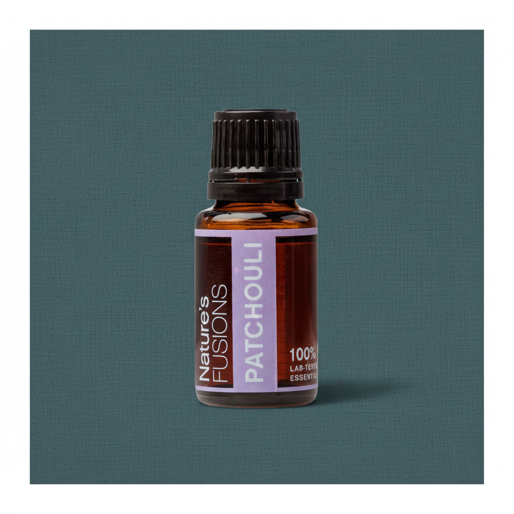 Close-up of amber glass bottle of Patchouli Essential Oil with black ribbed cap on muted teal textured background in soft directional light. — for Carpe Diem Dream