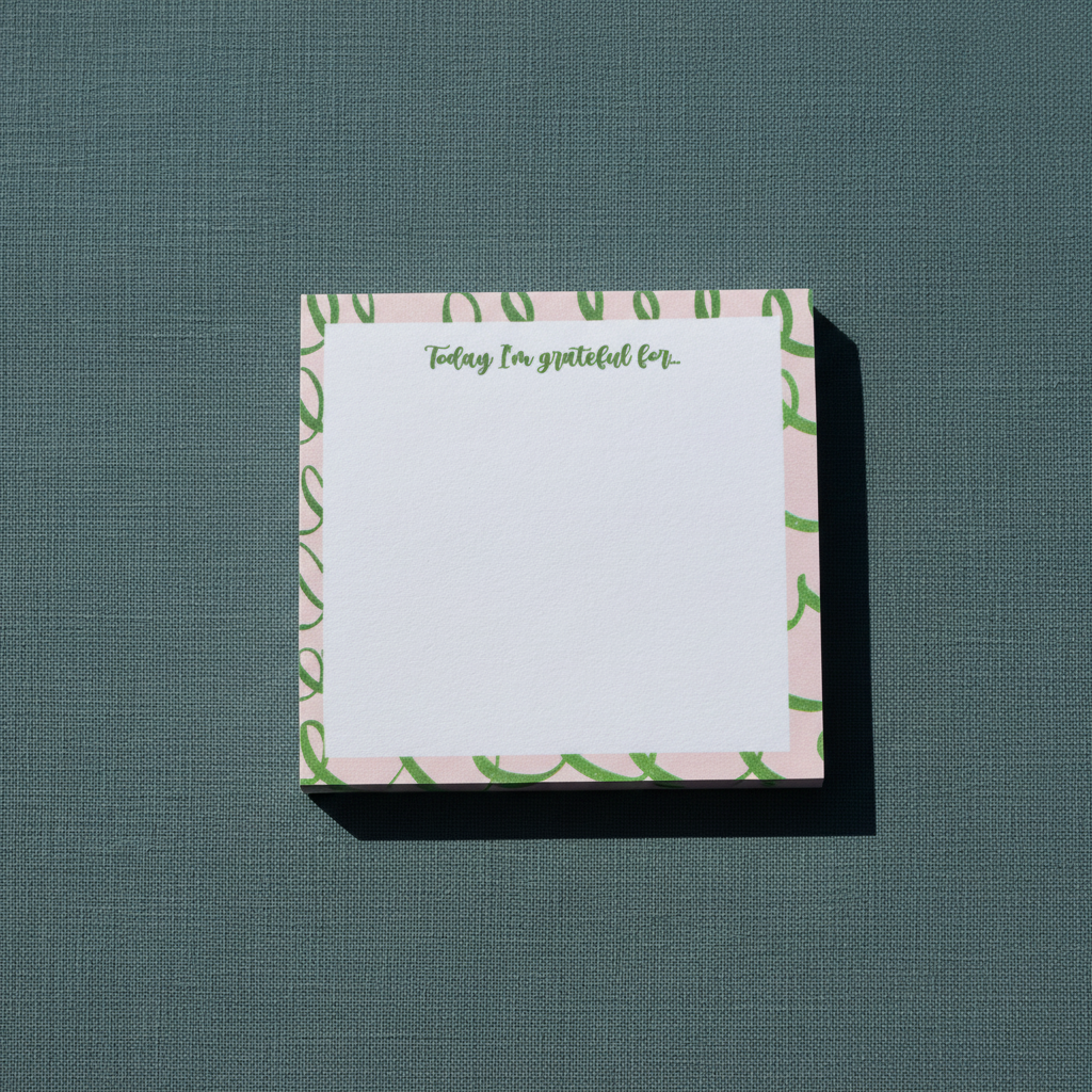 Square pink and green gratitude sticky note pad with “Today I’m grateful for” text displayed on a textured muted teal surface. — for Carpe Diem Dream