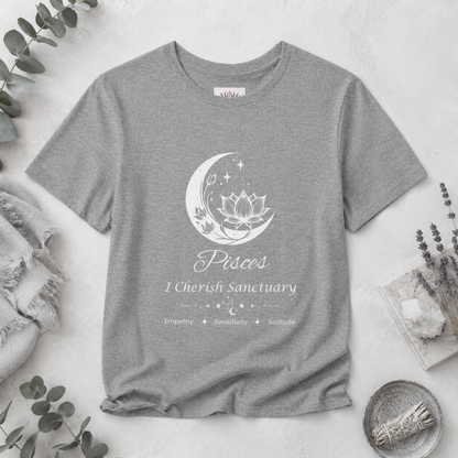 Pisces Moon I Cherish Sanctuary zodiac T-shirt in Athletic Heather with white moon-inspired lotus, floral, and celestial artwork and Empathy, Sensitivity, Solitude text, styled in a cool-toned studio botanical flat lay. — for Carpe Diem Dream