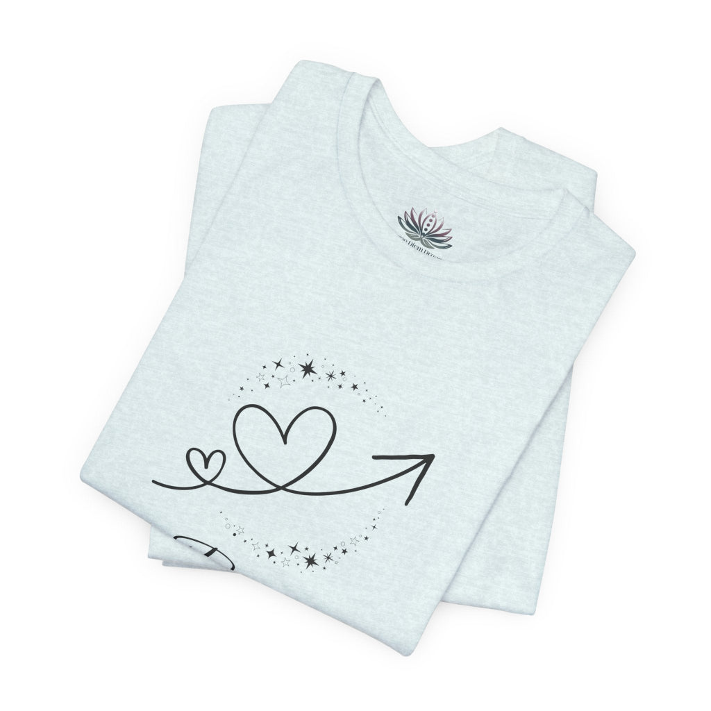 Pisces Rising I Sense zodiac T-shirt in Heather Ice Blue with black celestial heart and arrow artwork, shown folded in a supplier mockup. — for Carpe Diem Dream