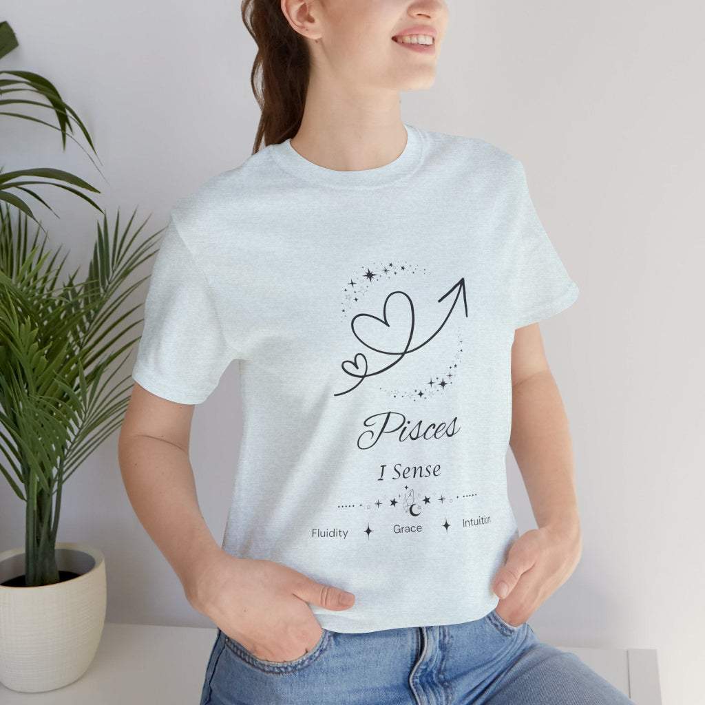 Model wearing a Heather Ice Blue Pisces Rising I Sense zodiac T-shirt with black celestial heart and arrow artwork. — for Carpe Diem Dream
