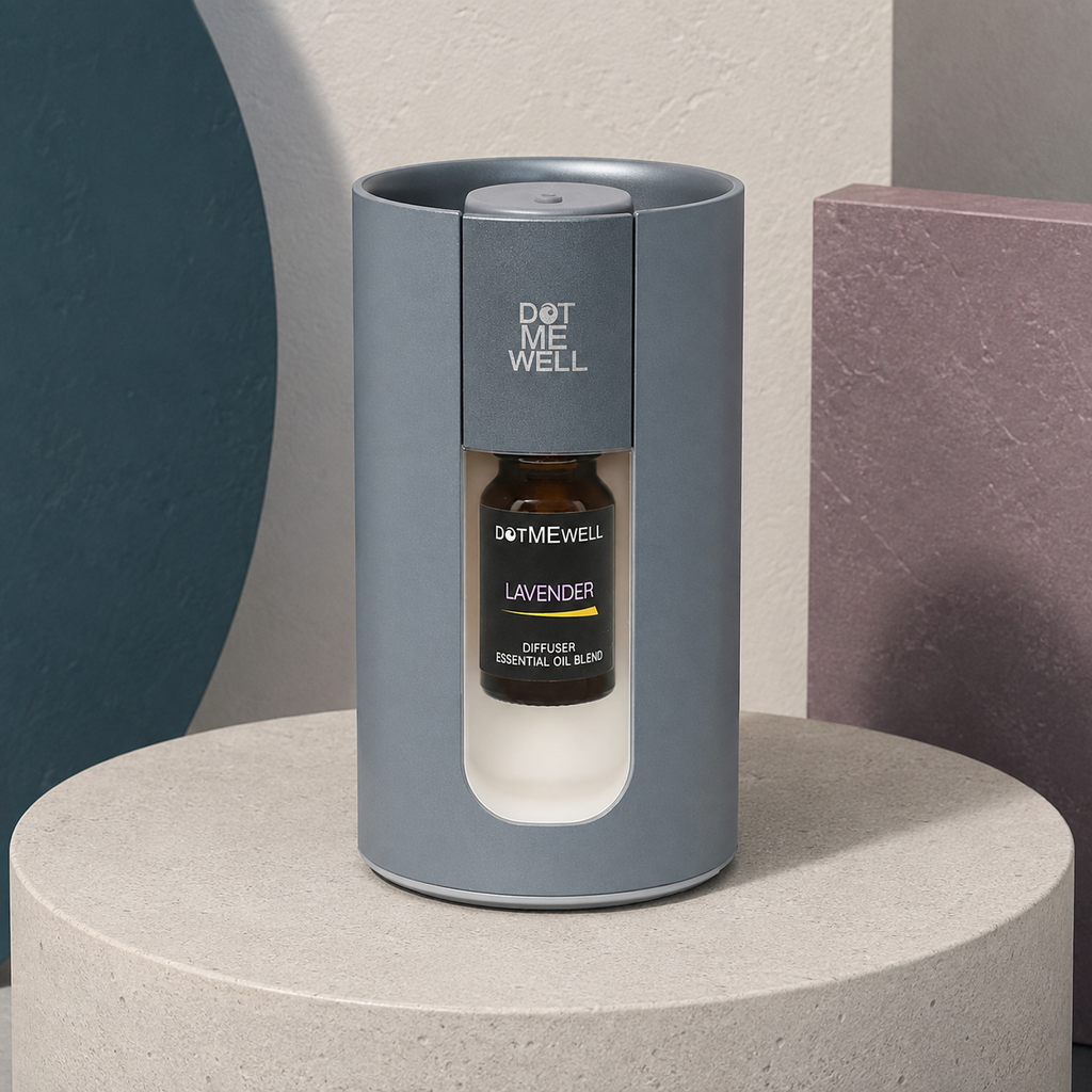Portable waterless essential oil diffuser shown from an elevated angle on a pale stone pedestal with dark teal and mauve panels, highlighting the open rim, top button, and Lavender bottle. — for Carpe Diem Dream