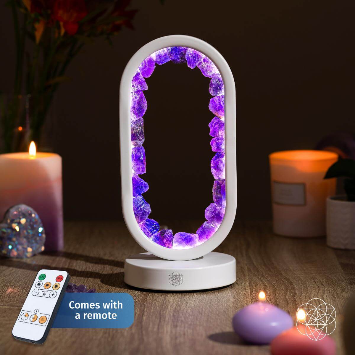 Decorative lamp with purple gemstones on a wooden surface with candles and a remote control. Carpe Diem Dream