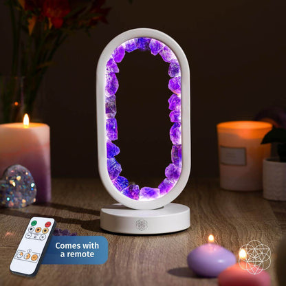 Decorative lamp with purple gemstones on a wooden surface with candles and a remote control. Carpe Diem Dream