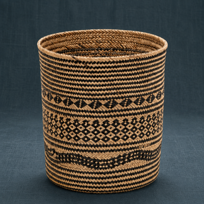 Praya handwoven rattan basket with black geometric woven motif on a dark teal linen backdrop. — for Carpe Diem Dream