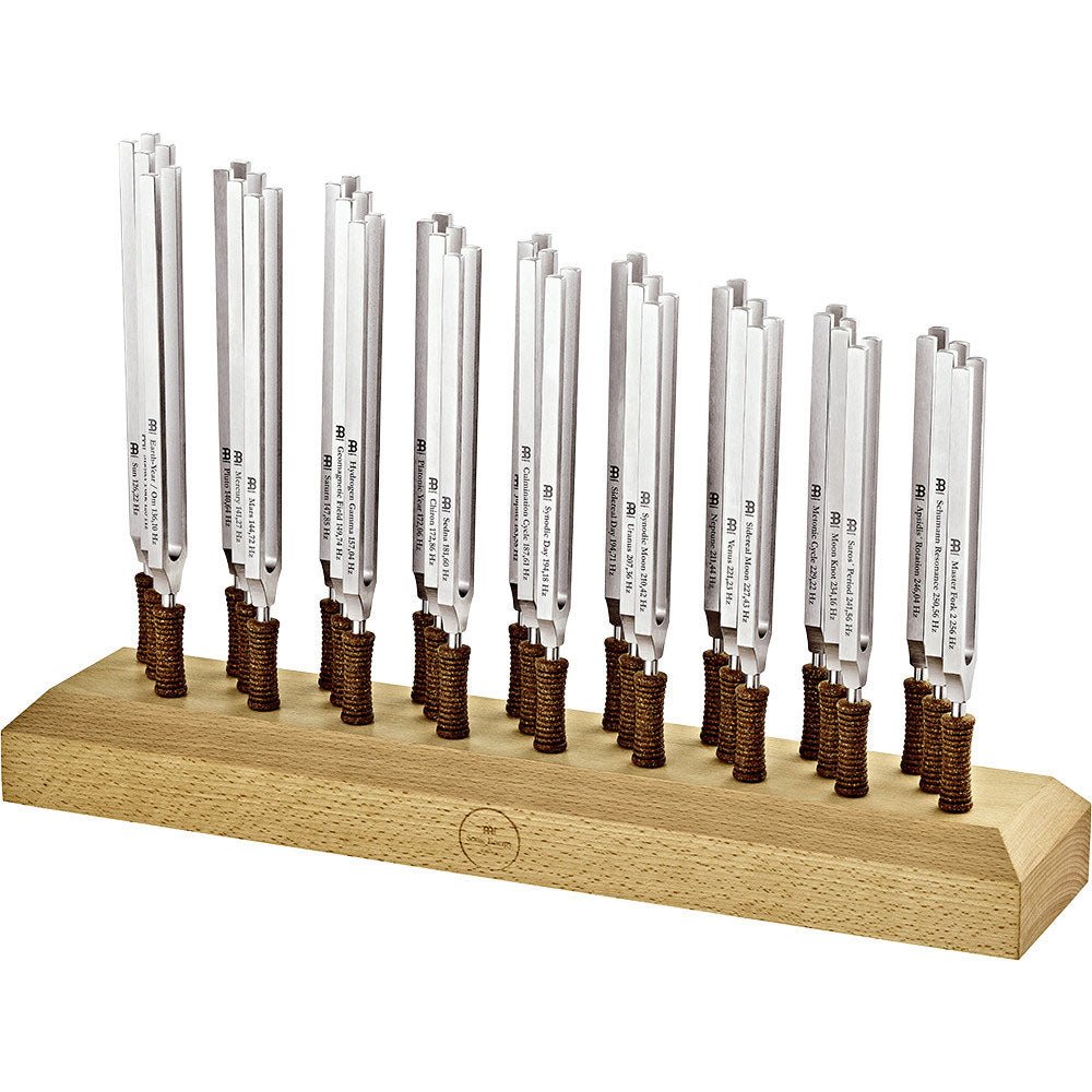 Twenty-seven weighted planetary therapy tuning forks standing upright in a wooden holder against a clean white background. — for Carpe Diem Dream