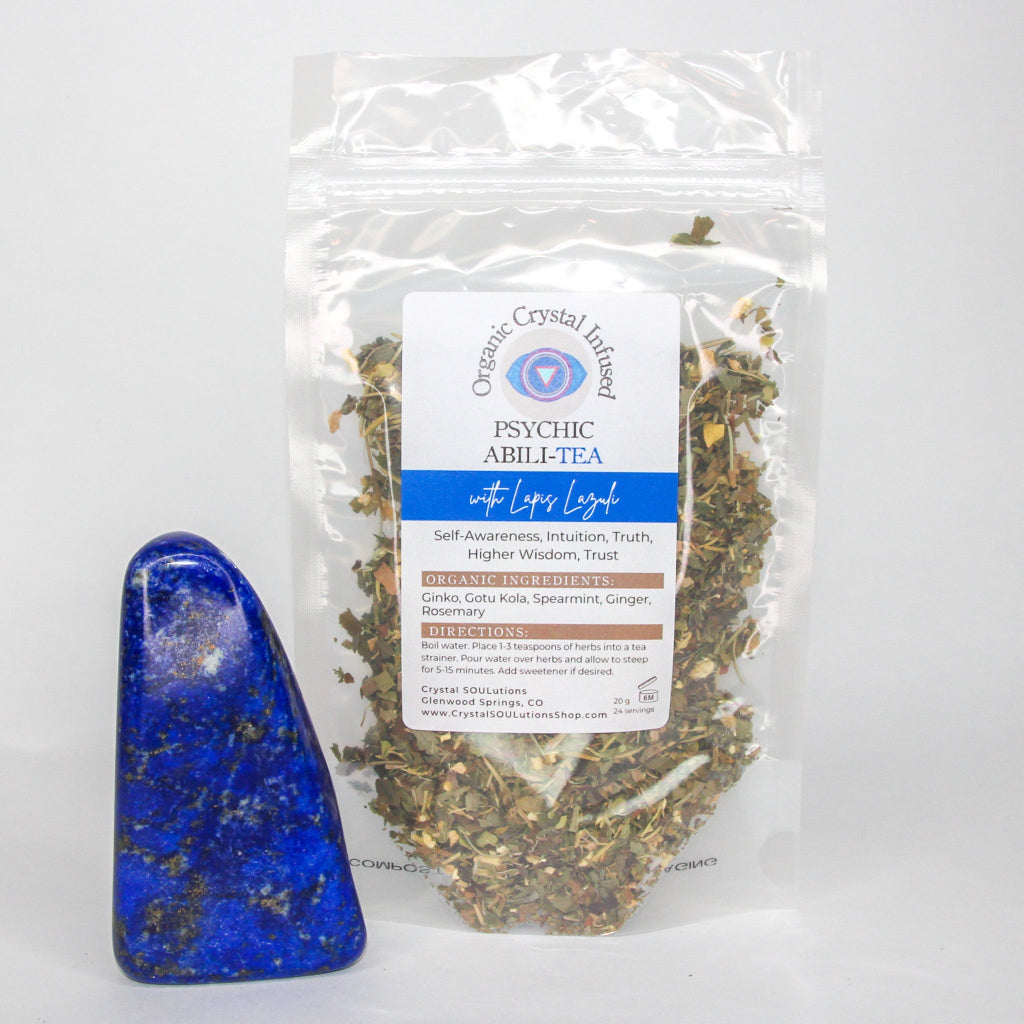 Psychic Abili-Tea – Organic Crystal Infused 20g loose-leaf herbal tea with Lapis Lazuli crystal energy displayed beside a polished lapis lazuli stone and visible herbal tea blend on a clean white background. — for Carpe Diem Dream