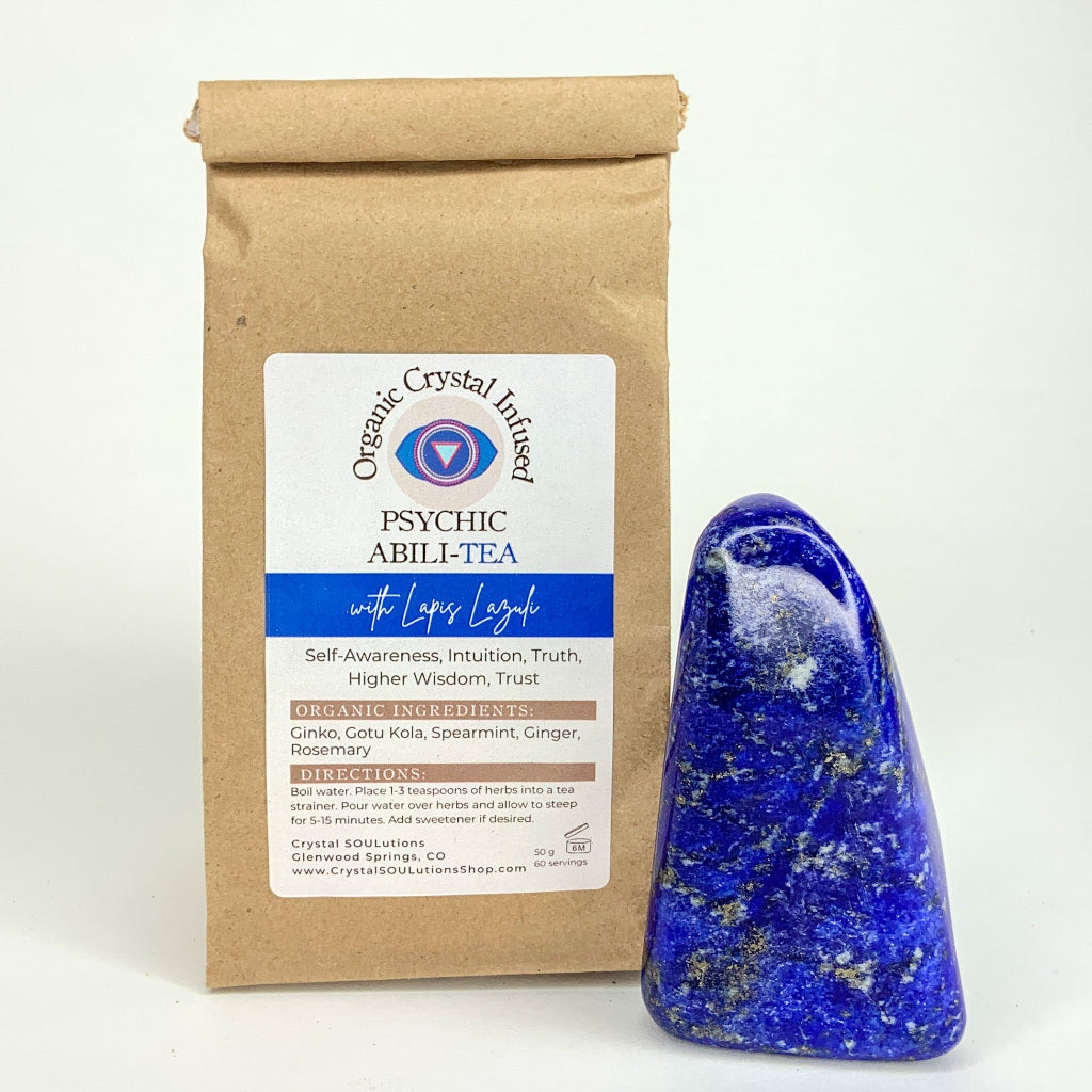 Psychic Abili-Tea – Organic Crystal Infused 50g loose-leaf herbal tea with Lapis Lazuli crystal energy displayed beside a polished lapis lazuli stone on a clean white background. — for Carpe Diem Dream