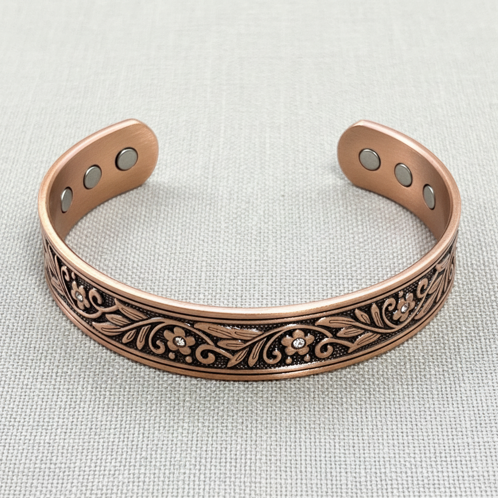 A close-up view of a pure copper floral cuff bracelet showing leaf detailing, engraved patterns, and magnetic elements on a soft neutral textured background. — for Carpe Diem Dream

