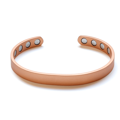 A pure copper magnetic cuff bracelet with an open adjustable design and visible magnet inserts displayed on a white background. — for Carpe Diem Dream