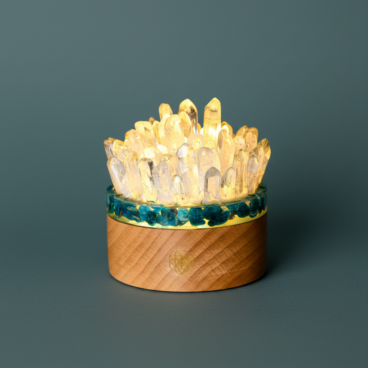 A quartz and apatite crystal lamp with illuminated crystal points set in a natural wood base against a deep teal background. — for Carpe Diem Dream