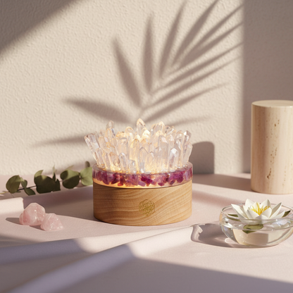 A glowing cluster of clear quartz points rising from a pink tourmaline base on a soft blush satin surface beside eucalyptus sprigs and a floating lotus bowl in warm natural light. — for Carpe Diem Dream