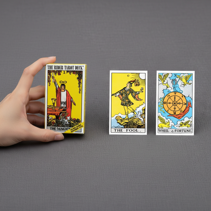 Rider Waite tarot card deck held in hand beside two tarot cards to show size and scale against a neutral background. — for Carpe Diem Dream