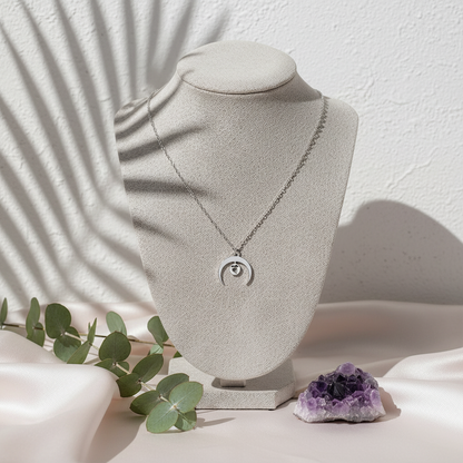 Sacral Chakra Moon Coin Necklace displayed on white jewelry bust with pink silk, eucalyptus, and amethyst — for Carpe Diem Dream