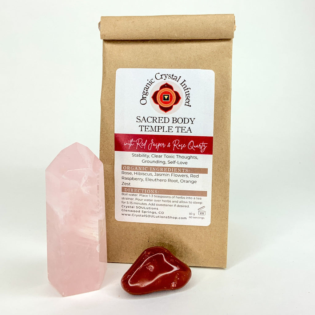 Sacred Body Temple Tea – Organic Crystal Infused 50g loose-leaf herbal tea with Red Jasper and Rose Quartz crystal energy, displayed beside polished crystal specimens on a clean white background. — for Carpe Diem Dream