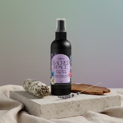 Sacred Space Smudge Spray bottle displayed on a travertine slab with sage bundle, palo santo wood, and lavender on a neutral background. — for Carpe Diem Dream