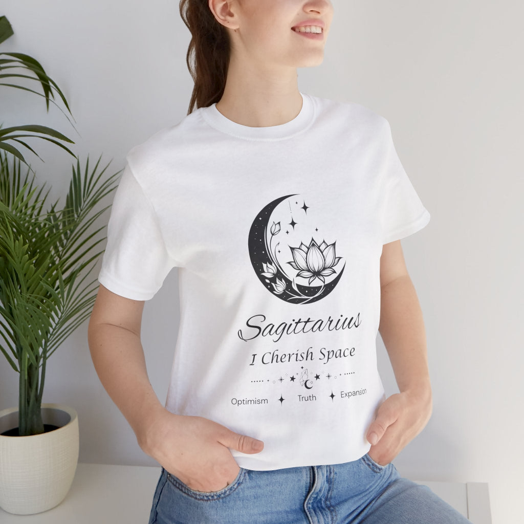 Model wearing a white Sagittarius Moon I Cherish Space zodiac T-shirt with black moon-inspired lotus, floral, and celestial artwork. — for Carpe Diem Dream