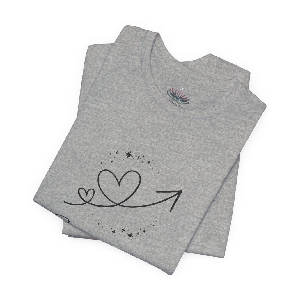Sagittarius Rising I Explore zodiac T-shirt in Athletic Heather with black celestial heart and arrow artwork, shown folded in a supplier mockup. — for Carpe Diem Dream