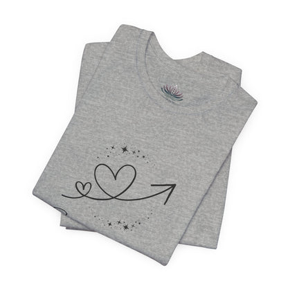 Sagittarius Rising I Explore zodiac T-shirt in Athletic Heather with black celestial heart and arrow artwork, shown folded in a supplier mockup. — for Carpe Diem Dream