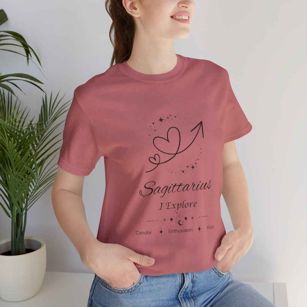 Model wearing a mauve Sagittarius Rising I Explore zodiac T-shirt with black celestial heart and arrow artwork. — for Carpe Diem Dream