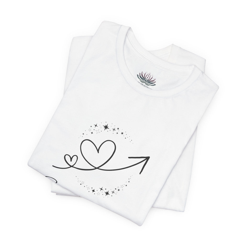 Sagittarius Rising I Explore zodiac T-shirt in white with black celestial heart and arrow artwork, shown folded in a supplier mockup. — for Carpe Diem Dream