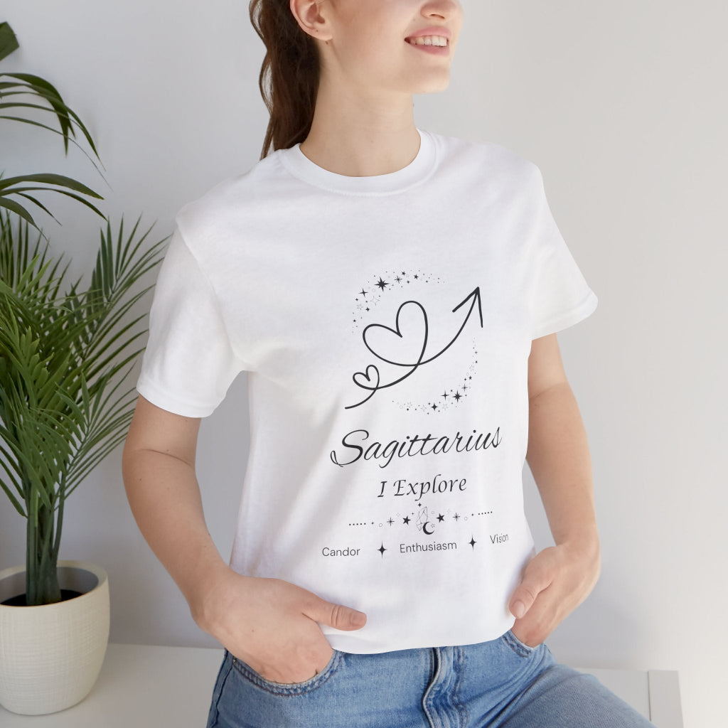 Model wearing a white Sagittarius Rising I Explore zodiac T-shirt with black celestial heart and arrow artwork. — for Carpe Diem Dream