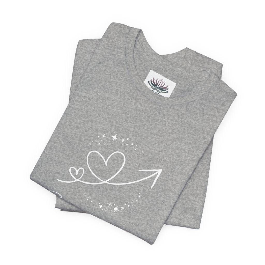 Sagittarius Rising I Explore zodiac T-shirt in Athletic Heather with white celestial heart and arrow artwork, shown folded in a supplier mockup. — for Carpe Diem Dream