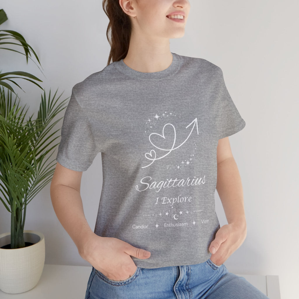 Model wearing an Athletic Heather Sagittarius Rising I Explore zodiac T-shirt with white celestial heart and arrow artwork. — for Carpe Diem Dream