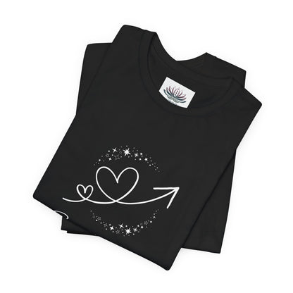 Sagittarius Rising I Explore zodiac T-shirt in black with white celestial heart and arrow artwork, shown folded in a supplier mockup. — for Carpe Diem Dream