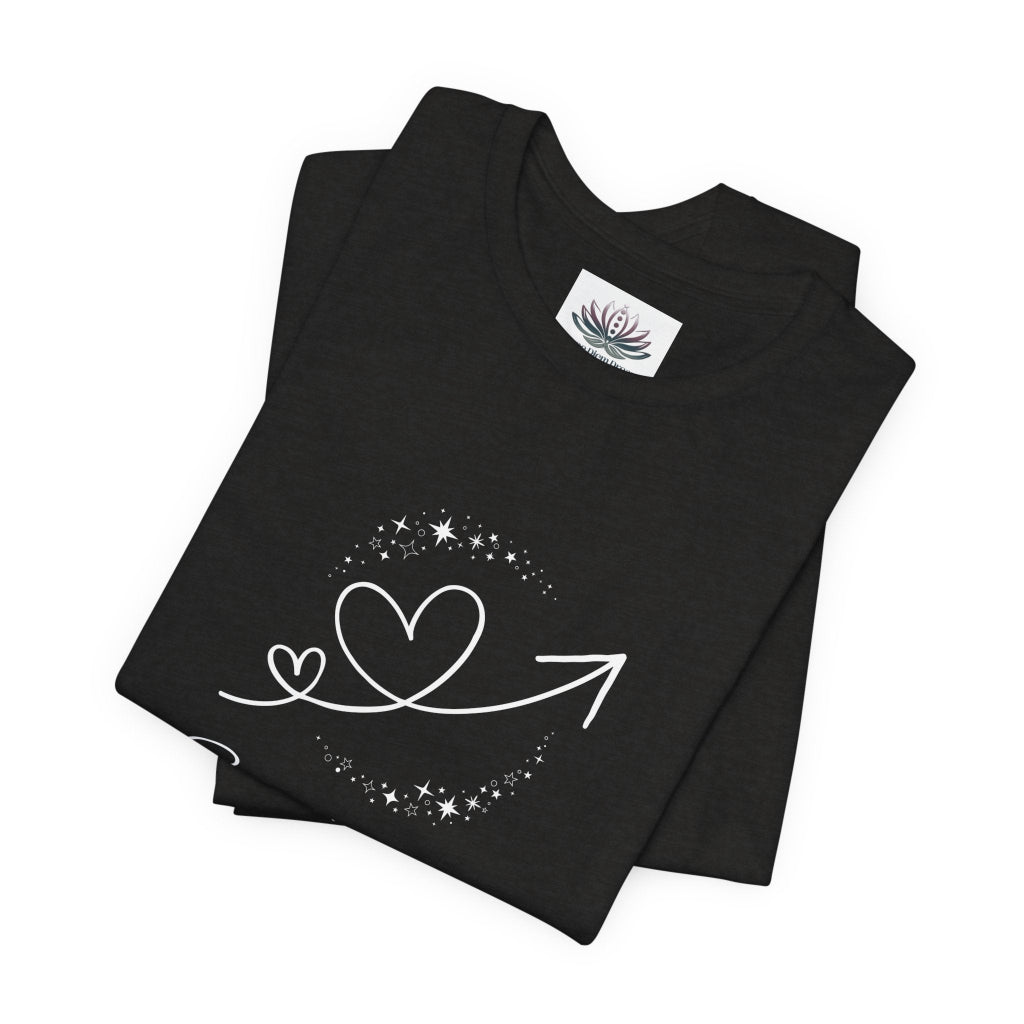 Sagittarius Rising I Explore zodiac T-shirt in Black Heather with white celestial heart and arrow artwork, shown folded in a supplier mockup. — for Carpe Diem Dream