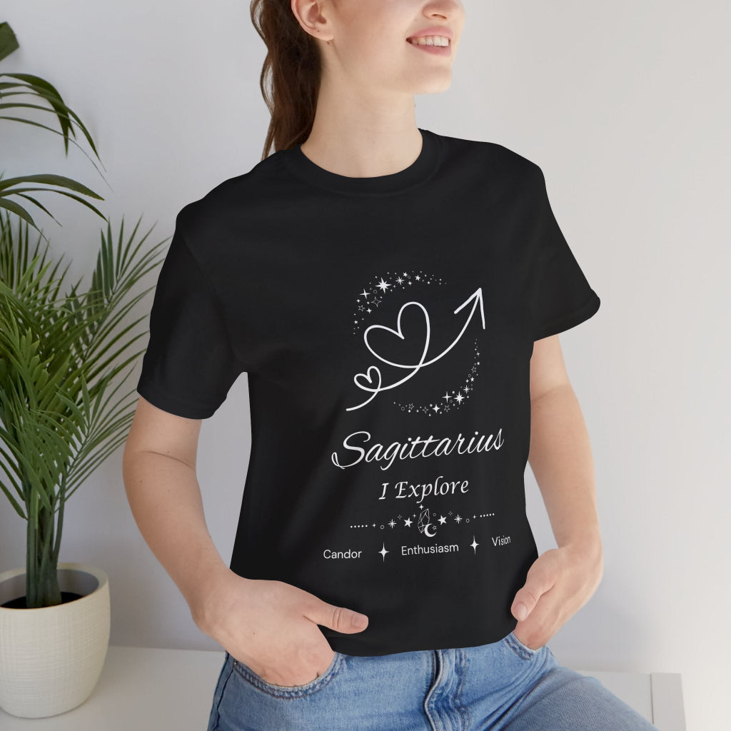 Model wearing a black Sagittarius Rising I Explore zodiac T-shirt with white celestial heart and arrow artwork. — for Carpe Diem Dream