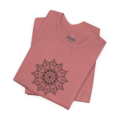 Sagittarius Sun I See zodiac T-shirt in mauve with black sun-inspired mandala artwork, shown folded with Carpe Diem Dream neck label in a supplier mockup. — for Carpe Diem Dream