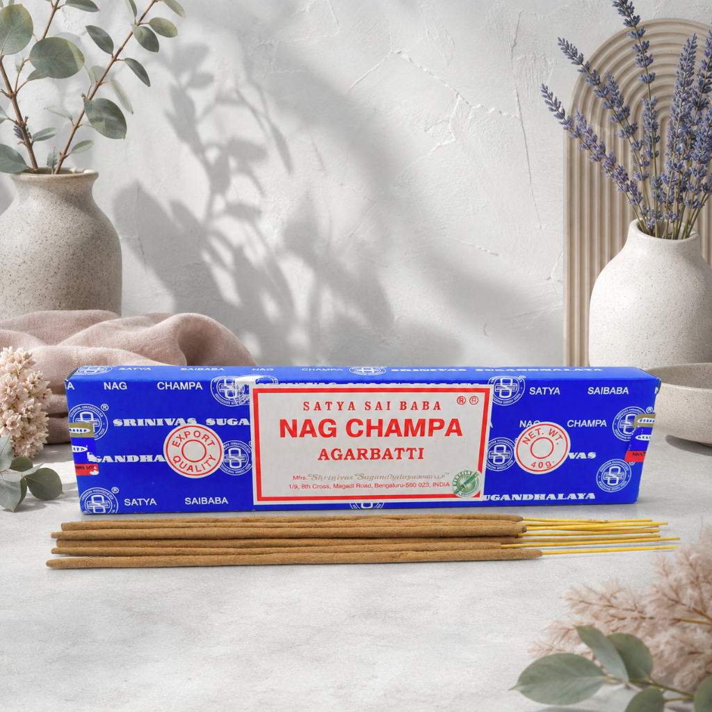Satya Nag Champa incense box and sticks styled in the CDD Studio Botanical setting with cool pale stone, eucalyptus, lavender, soft mauve textile, and botanical shadows. — for Carpe Diem Dream.