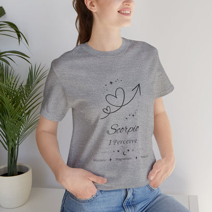 Model wearing an Athletic Heather Scorpio Rising I Perceive zodiac T-shirt with black celestial heart and arrow artwork. — for Carpe Diem Dream